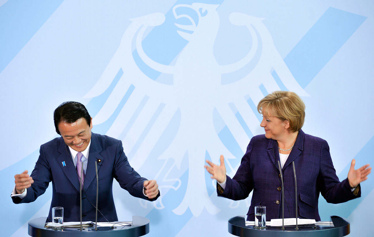 German Chancellor Angela Merkel, right, and Japanese Prime Minister Taro Aso, left, gesture during a news conference in Berlin, Germany, on Tuesday, May 05, 2009. Aso is on a one-day visit to Germany. (AP Photo/Gero Breloer)